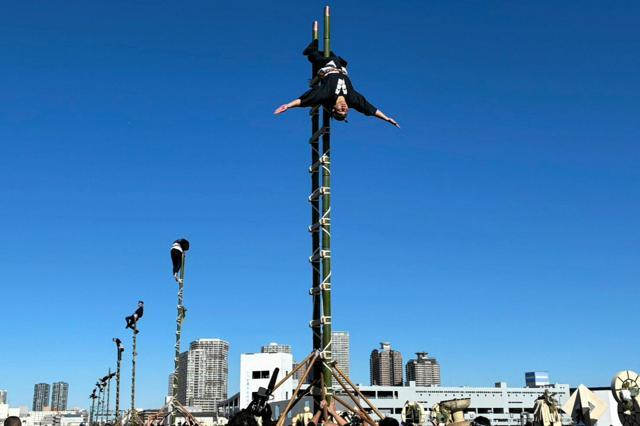 出初め式で「はしご乗り」を披露する人たち